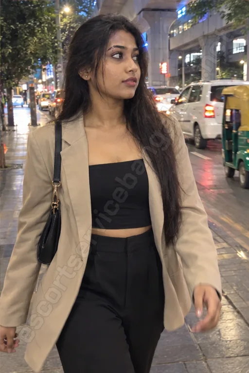 Avni in a beige blazer walking on MG Road boulevard