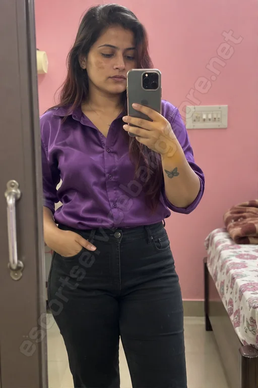 Raveena in a purple shirt - mirror selfie in her Rajajinagar flat